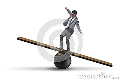 The businessman balancing on seesaw in uncertainty concept Stock Photo