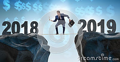 Businessman balancing between 2018 and 2018 years Stock Photo