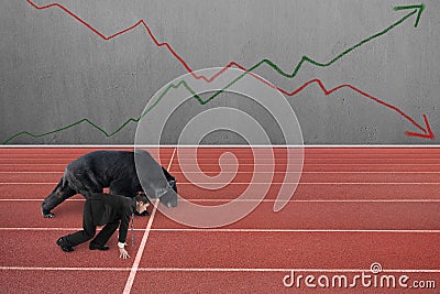 Businessman and bear are ready to race on running track Stock Photo