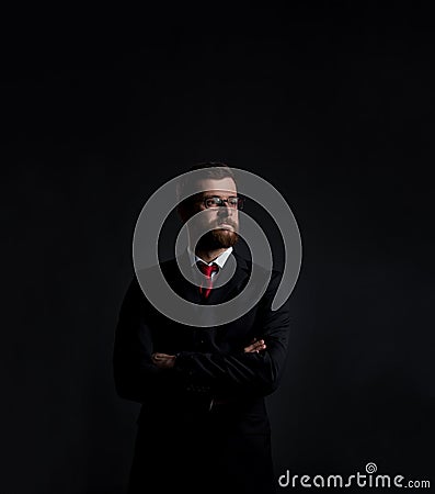 Businessman with beard. Black background with copyspace. Stock Photo