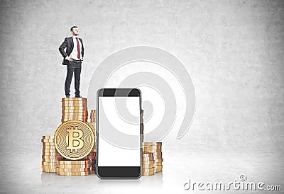 Businessman on bitcoin stacks, smartphone screen Stock Photo