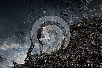 Businessman with black umbrella. Mixed media . Mixed media Stock Photo