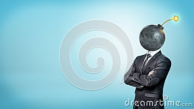 A businessman on blue background standing with his hands crossed with a bomb instead of his head. Stock Photo