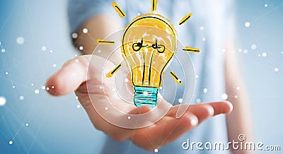 Businessman holding and touching a lightbulb sketch Stock Photo