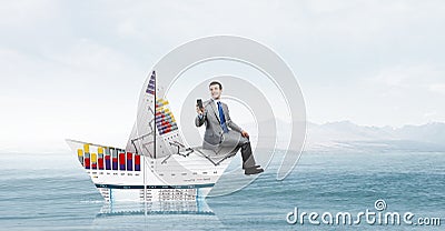Businessman in boat made of paper Stock Photo