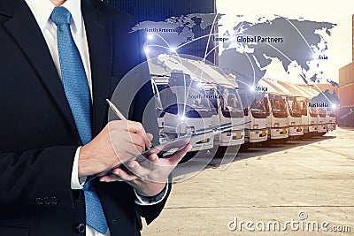 Businessman is booking with blurred cargo , transportation port Stock Photo