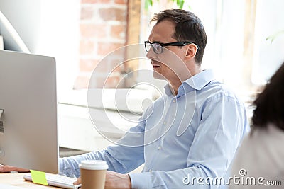 Businessman, boss looking at monitor screen squinting Stock Photo