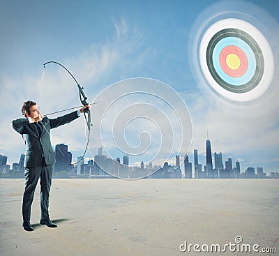 Businessman with bow and arrow Stock Photo