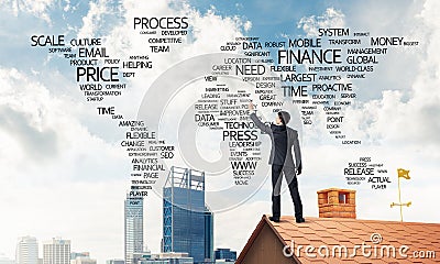 Businessman on brick roof draw world map as concept of globaliza Stock Photo