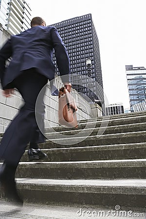 Businessman With Briefcase Ascending Steps Stock Photo