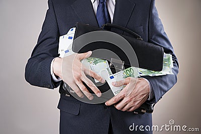 Businessman with a briefcase full of money in the hands of Stock Photo