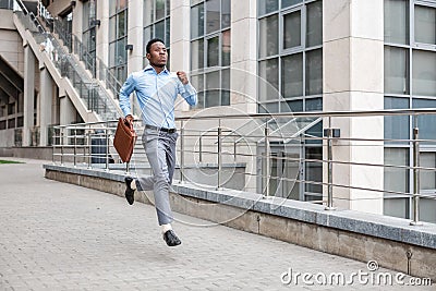 Businessman with briefcase running Stock Photo