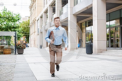 Businessman with briefcase running Stock Photo