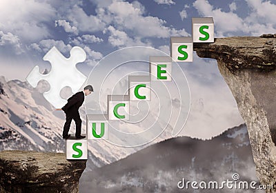 Businessman bring puzzle symbol of success at mountain Stock Photo