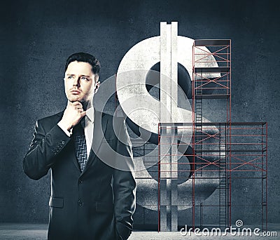 Businessman builder and dollar under construction Stock Photo