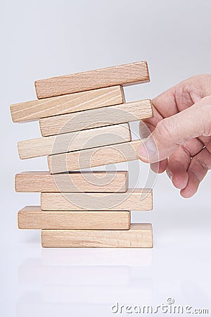 Businessman, building, brand concept with wooden blocks. Stock Photo