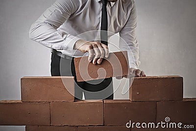 Businessman building a wall Stock Photo