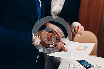 Businessman and businesswoman accountant team showing graph chart at office meeting. Business people group conference Stock Photo