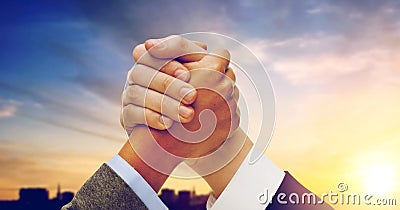 Businessman and businesswoman arm wrestling Stock Photo