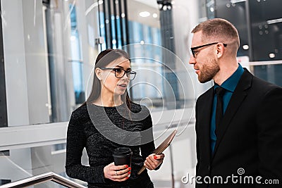 Businessman and businesswoman discussing something during the coffee break Stock Photo
