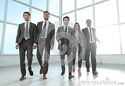 Business people go down the hallway of a modern office Stock Photo