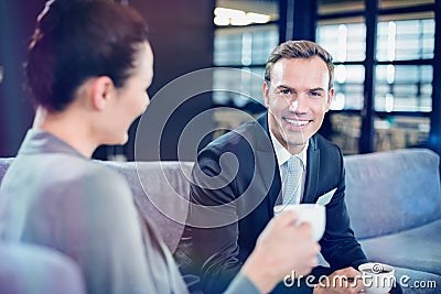 Businessman and businesswoman having tea during breaktime Stock Photo