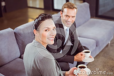Businessman and businesswoman having tea during breaktime Stock Photo