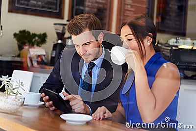 Businessman And Businesswoman Meeting In Coffee Shop Stock Photo
