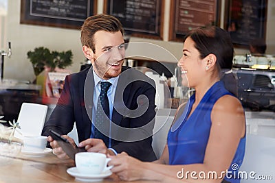 Businessman And Businesswoman Meeting In Coffee Shop Stock Photo