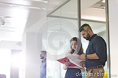 Businessman and businesswoman reviewing project in office Stock Photo