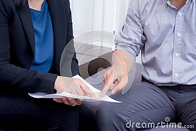 businessman and businesswoman talking about discussed document. Stock Photo