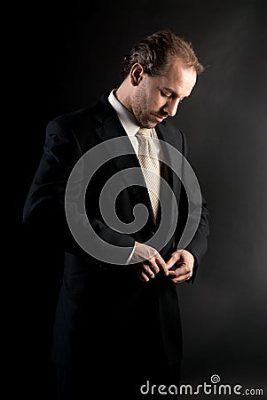 Businessman buttoning jacket, getting dressed. Stock Photo