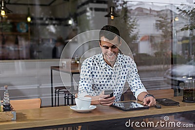 Businessman in a cafe talking on the phone Stock Photo