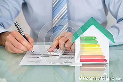 Businessman Calculating Energy Efficiency Rate Stock Photo