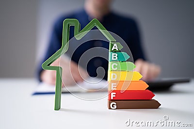 Businessman Calculating Energy Efficiency Rate Stock Photo