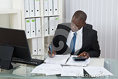 Businessman Calculating Finance Bills Stock Photo