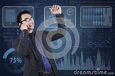 Businessman calling near financial statistics Stock Photo