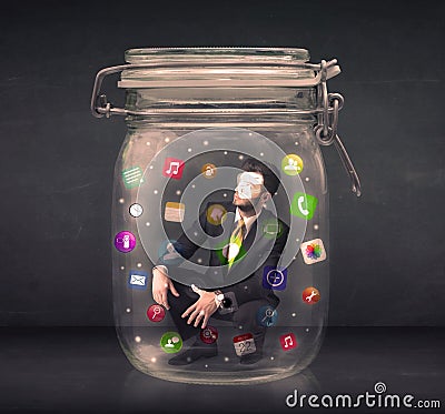 Businessman captured in a glass jar with colourful app icons con Stock Photo