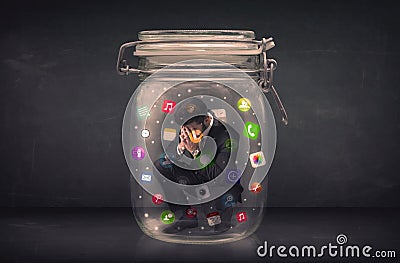 Businessman captured in a glass jar with colourful app icons concept Editorial Stock Photo