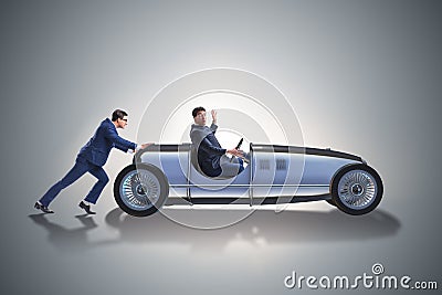 The businessman car pushing in teamwork concept Stock Photo