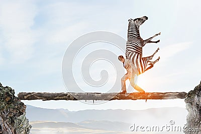 Businessman carrying zebra . Mixed media Stock Photo