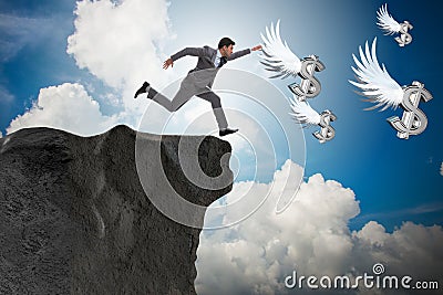 The businessman chasing angel dollars in business concept Stock Photo