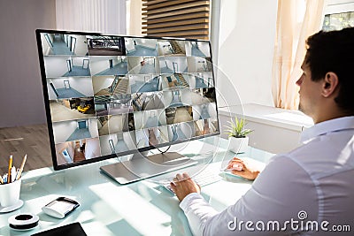 Businessman checking CCTV camera footage on computer Stock Photo