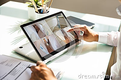 Businessman checking CCTV camera footage on laptop Stock Photo