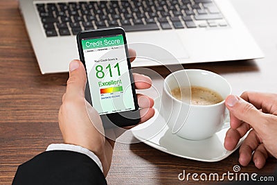 Businessman checking credit score on cellphone Stock Photo