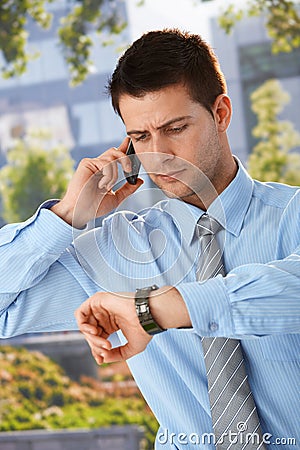 Businessman checking time Stock Photo