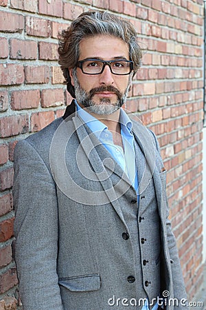 Businessman in classic suit and vest wearing glasses Stock Photo