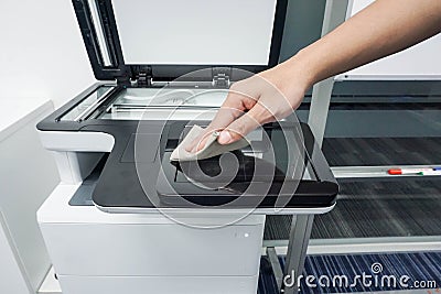 Businessman clean touch screen of office printer for maintenance Stock Photo