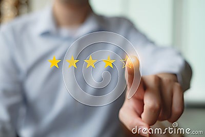 Businessman click on five yellow stars to increase rating. Stock Photo