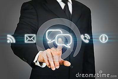 Businessman clicking on live chat icon Stock Photo